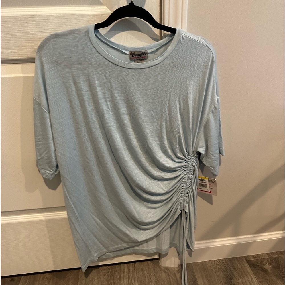 Women’s large Wrangler pale blue blouse new with tags.